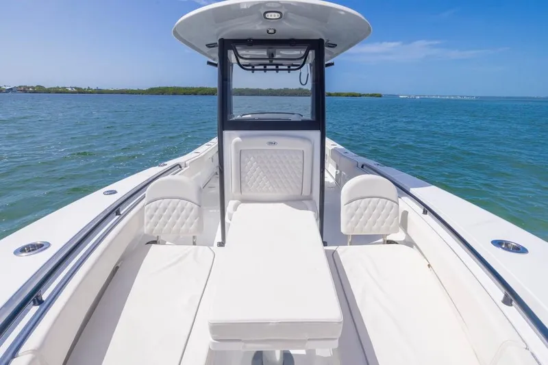 Slide: The Image of 2026 Sea Hunt Gamefish 27 Forward Seating boat on calm blue water. - 6