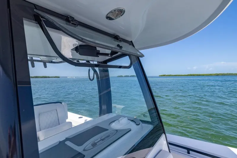 Slide: The Image of 2026 Sea Hunt Gamefish 27 boat with forward seating on calm waters. - 8