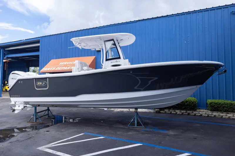 The Image of 2026 Sea Hunt Gamefish 27 Coffin Box boat displayed outside service department. - 1