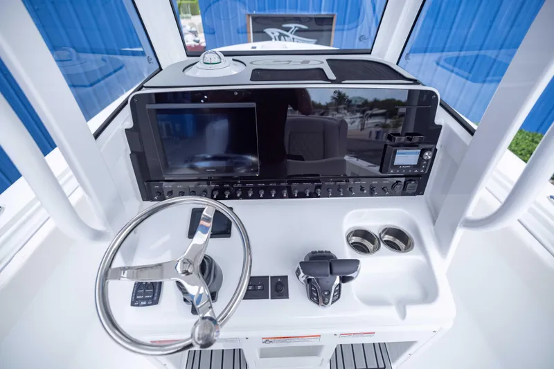 Slide: The Image of 2026 Sea Hunt Gamefish 27 Coffin Box helm with modern controls and navigation display. - 10