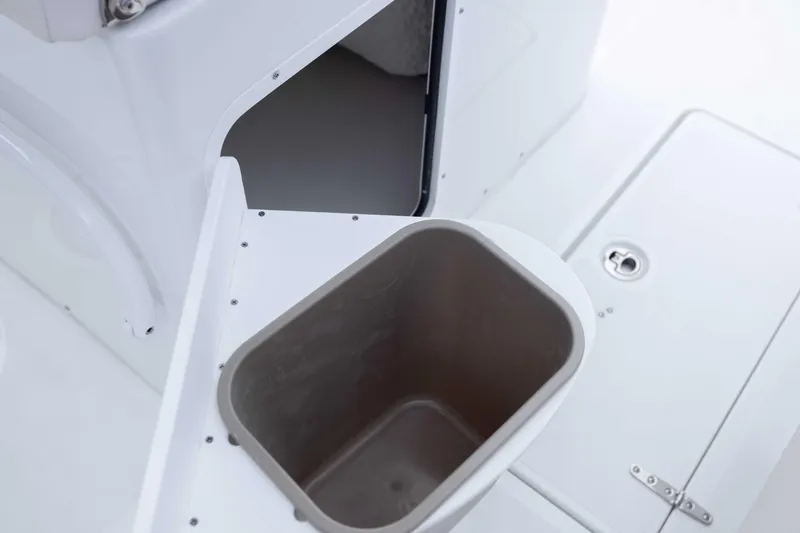 Slide: The Image of 2026 Sea Hunt Gamefish 27 Coffin Box interior with storage compartment and stainless steel bin. - 27