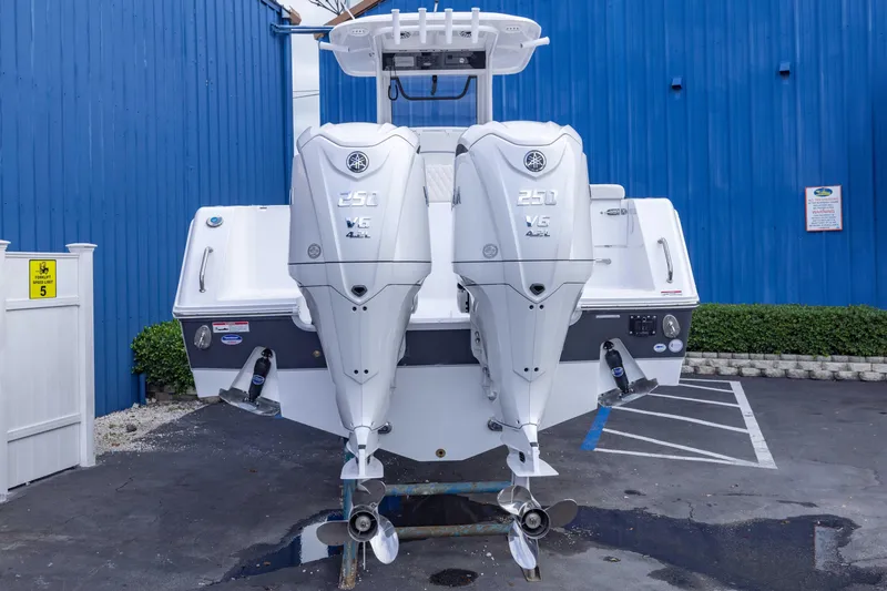 Slide: The Image of 2026 Sea Hunt Gamefish 27 Coffin Box with dual Yamaha 250 engines, parked outdoors. - 4