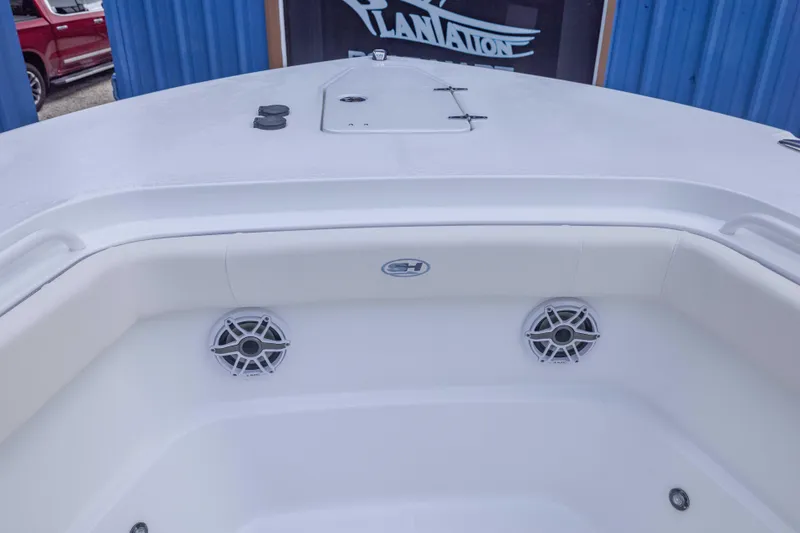 Slide: The Image of 2026 Sea Hunt Gamefish 27 Coffin Box boat interior with speakers and storage. - 6