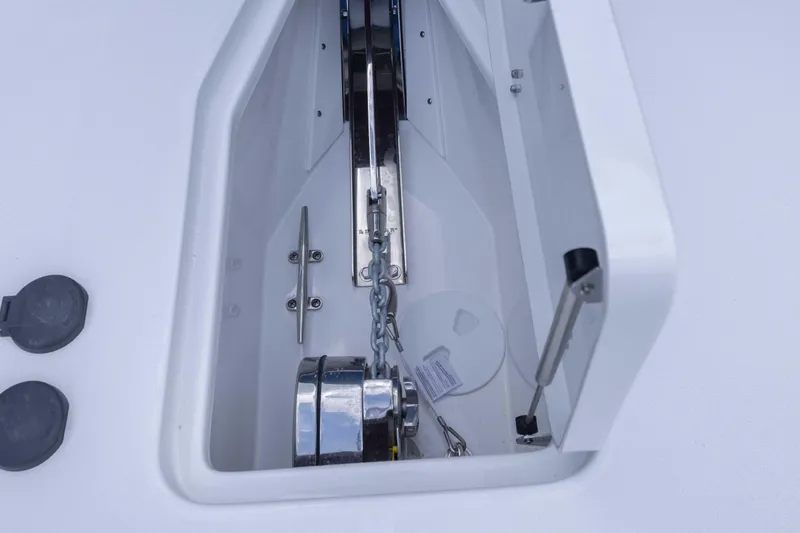 Slide: The Image of Anchor compartment of 2026 Sea Hunt Gamefish 27 Coffin Box boat, featuring chain and winch. - 7