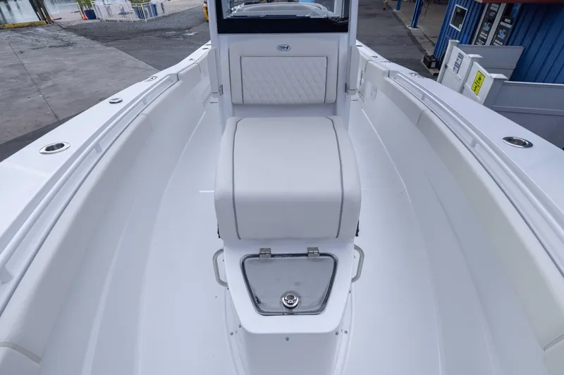 Slide: The Image of 2026 Sea Hunt Gamefish 27 Coffin Box boat interior, featuring sleek white seating and storage. - 8