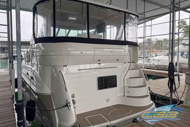 Slide: The Image of 2006 Sea Ray 40 Motor Yacht docked in marina, rear view with covered deck. - 1