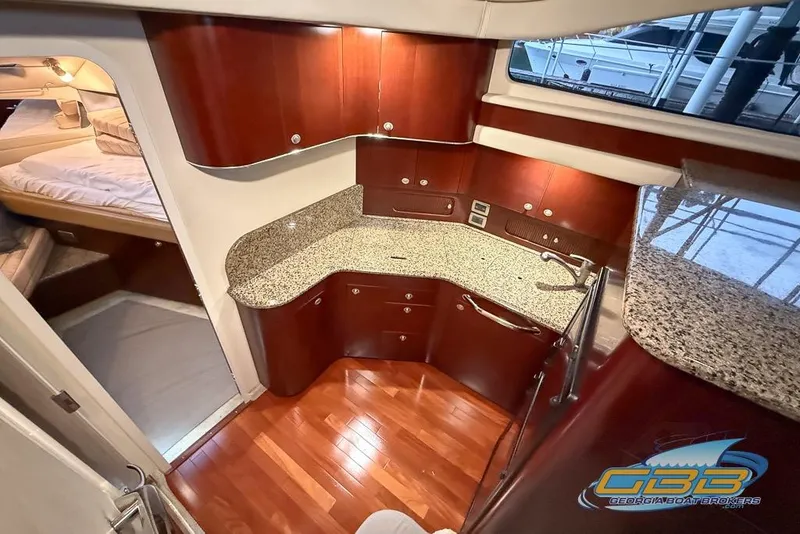 Slide: The Image of Luxurious 2006 Sea Ray 40 Motor Yacht interior with elegant wood cabinetry and granite countertops. - 12