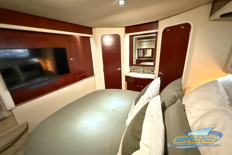 Slide: The Image of Luxurious 2006 Sea Ray 40 Motor Yacht bedroom with TV and elegant wood finishes. - 16