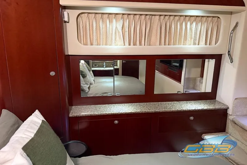 Slide: The Image of Luxurious interior of 2006 Sea Ray 40 Motor Yacht with wood cabinetry and mirrored accents. - 17