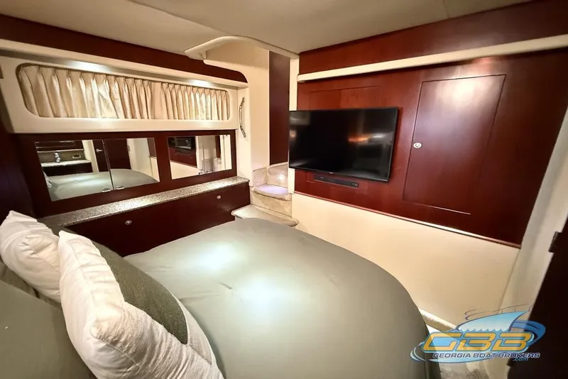 Slide: The Image of Luxurious 2006 Sea Ray 40 Motor Yacht bedroom with TV and elegant wood finishes. - 19