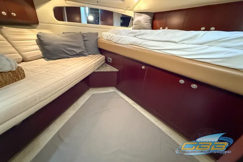 Slide: The Image of Luxurious 2006 Sea Ray 40 Motor Yacht cabin with plush bedding and elegant wood finishes. - 24