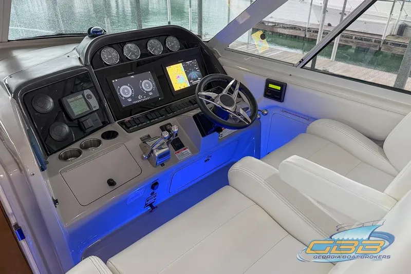 Slide: The Image of 2006 Sea Ray 40 Motor Yacht helm with modern navigation displays and luxurious seating. - 31