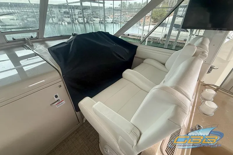 Slide: The Image of 2006 Sea Ray 40 Motor Yacht interior with white seating and marina view. - 7