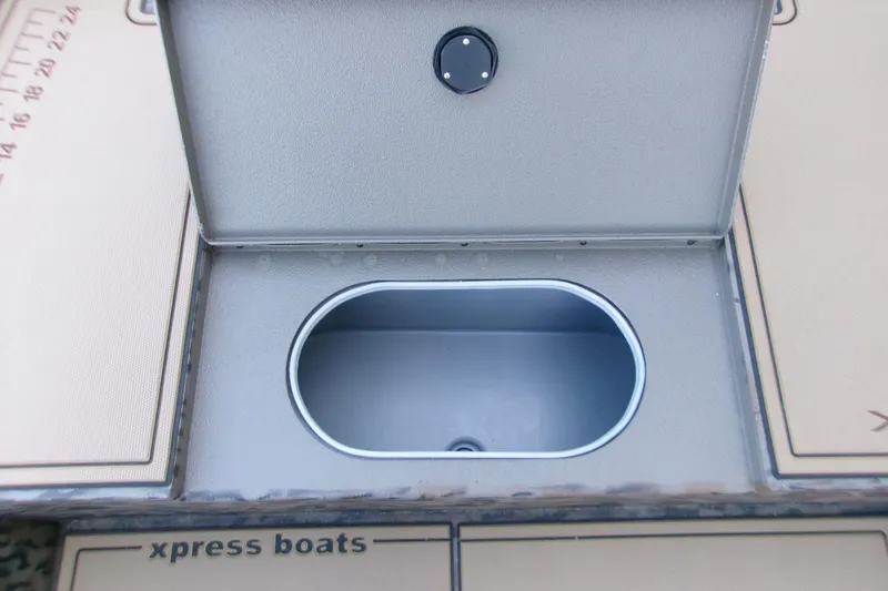Slide: The Image of Open storage compartment on 2026 Xpress X18DB boat deck. - 10
