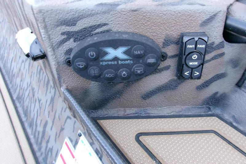 Slide: The Image of Control panel of 2026 Xpress X18DB boat with navigation and mode buttons. - 16