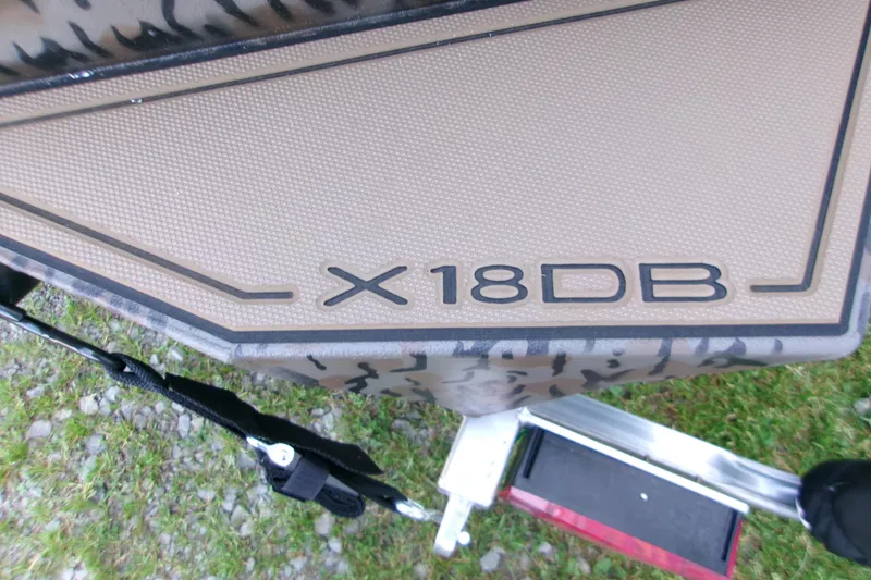 Slide: The Image of 2026 Xpress X18DB boat deck with textured surface and model branding. - 20