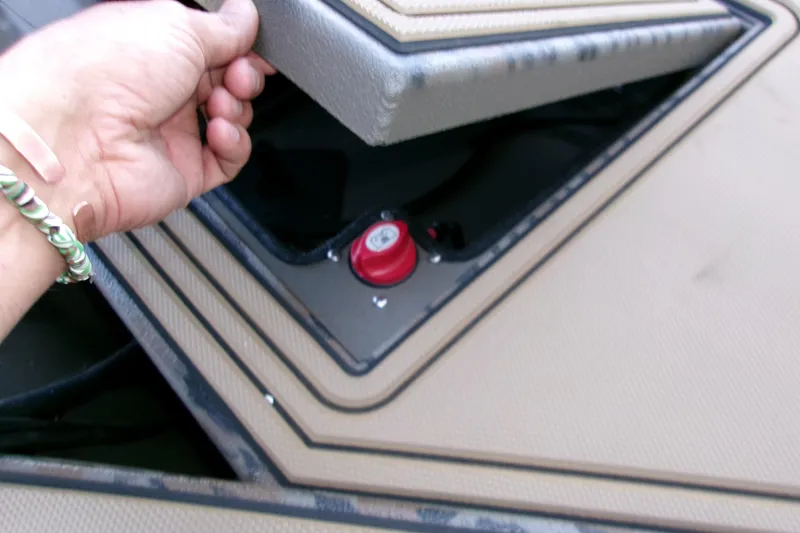 Slide: The Image of Hand opening compartment on 2026 Xpress X18DB boat, revealing red switch. - 5