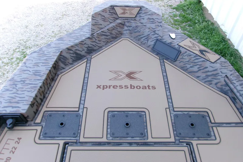 Slide: The Image of 2026 Xpress X18DB boat deck with camouflage design and logo. - 6