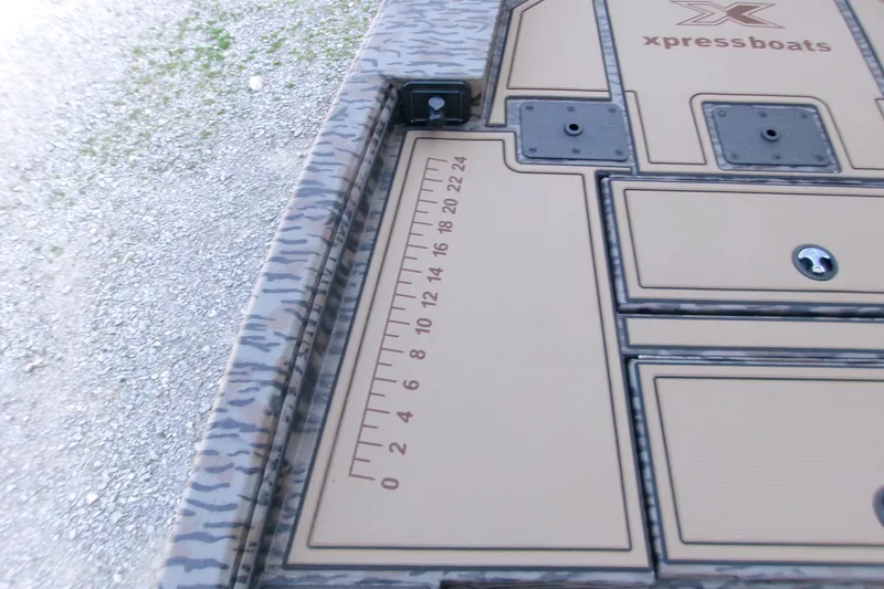 Slide: The Image of 2026 Xpress X18DB boat deck with measurement scale and storage compartments. - 7