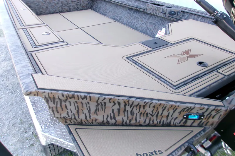 Slide: The Image of 2026 Xpress X18DB boat interior with camo design and storage compartments. - 9