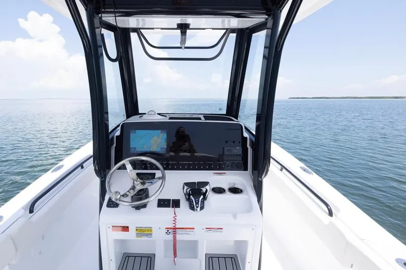 Slide: The Image of 2026 Sea Hunt Gamefish 25 helm with navigation system on open water. - 17
