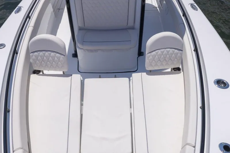 Slide: The Image of 2026 Sea Hunt Gamefish 25 boat interior with white cushioned seating and sleek design. - 6