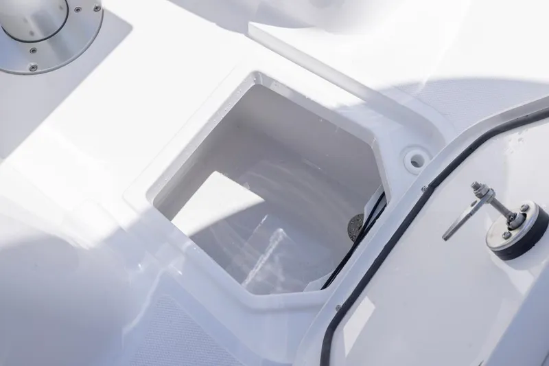 Slide: The Image of 2026 Sea Hunt Gamefish 25 boat storage compartment with open hatch. - 8