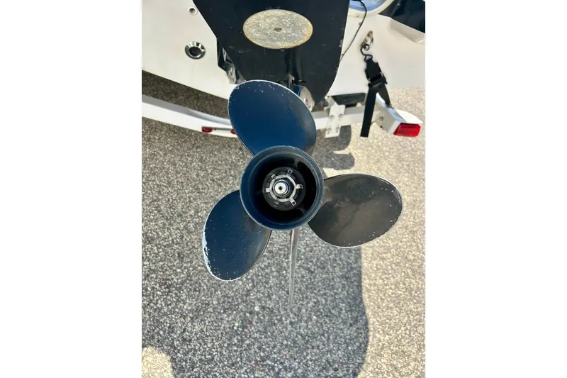 Slide: The Image of 2004 Starcraft Aurora 2000 OB boat propeller on asphalt background. - 10