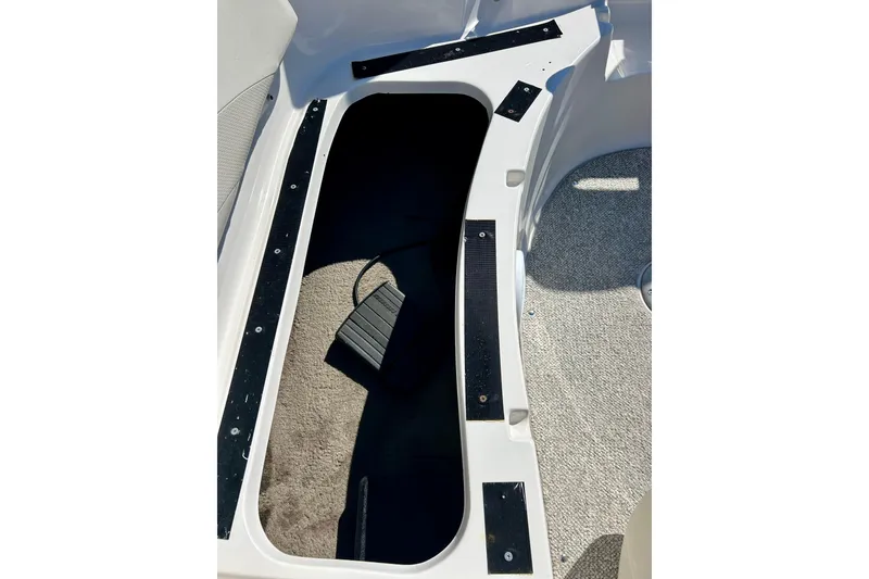 Slide: The Image of 2004 Starcraft Aurora 2000 OB boat interior storage compartment with carpeted flooring. - 22
