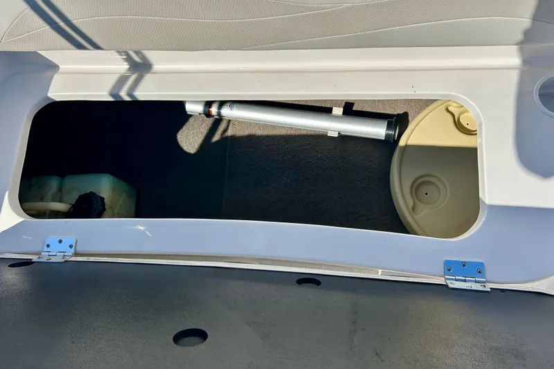 Slide: The Image of Open storage compartment in 2004 Starcraft Aurora 2000 OB boat, showing interior components. - 28