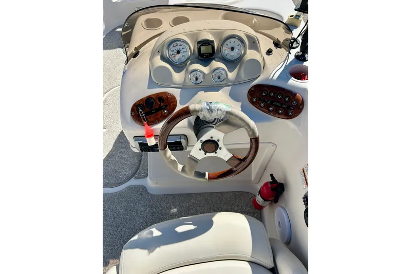 Slide: The Image of 2004 Starcraft Aurora 2000 OB boat dashboard with gauges and steering wheel. - 29