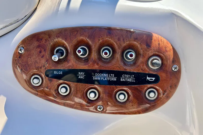 Slide: The Image of Control panel of a 2004 Starcraft Aurora 2000 OB boat with labeled switches. - 30