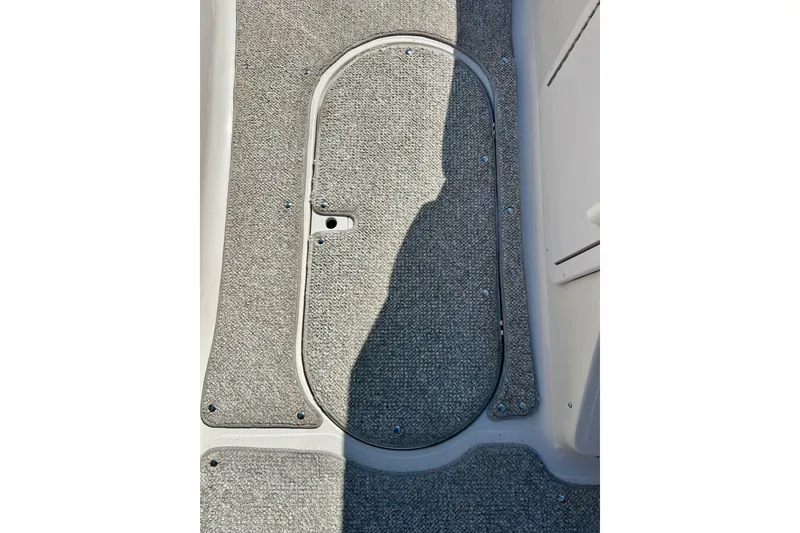 Slide: The Image of Carpeted deck of 2004 Starcraft Aurora 2000 OB boat, featuring storage hatch. - 40
