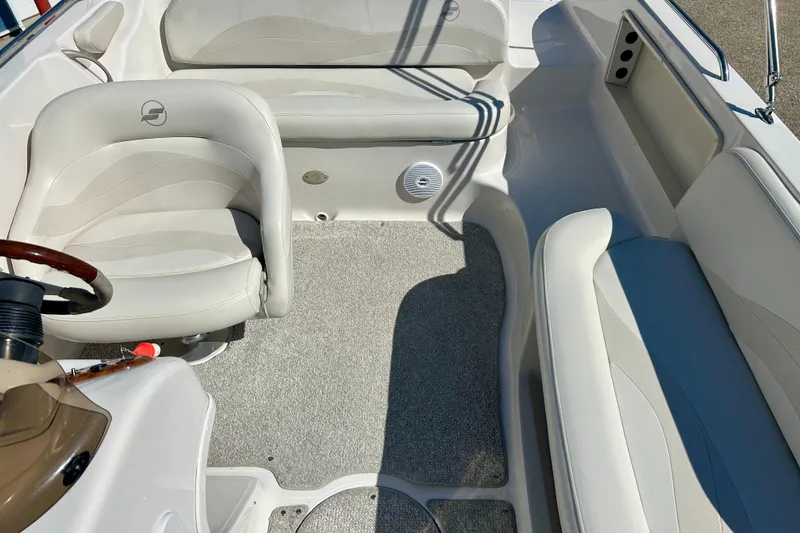 Slide: The Image of Interior of 2004 Starcraft Aurora 2000 OB boat with white seating and steering wheel. - 45