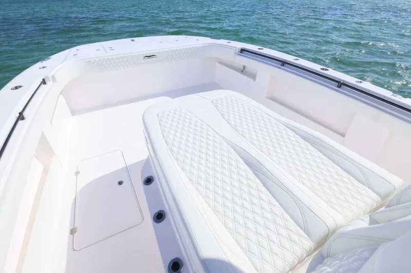 Slide: The Image of 2025 Invincible 35 Catamaran with luxurious white seating on open water. - 14