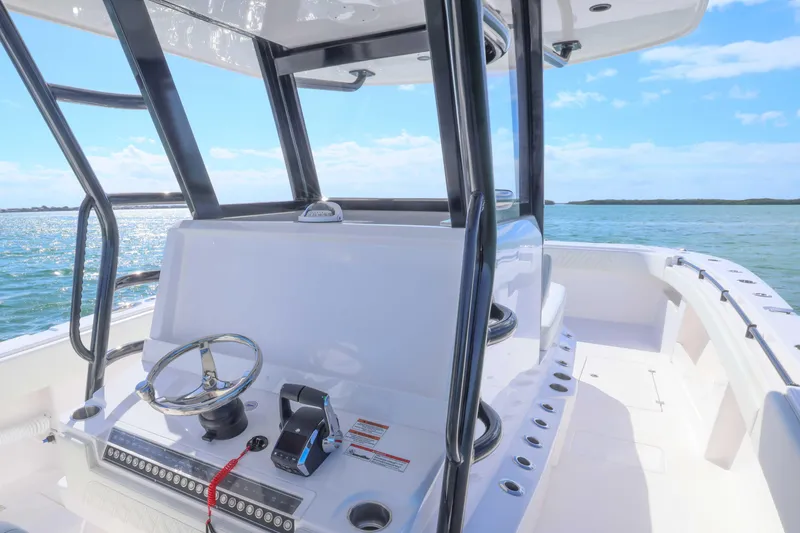 Slide: The Image of 2025 Invincible 35 Catamaran helm with ocean view, showcasing sleek design and modern controls. - 19