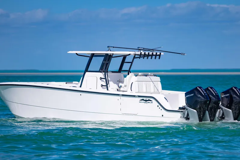 Slide: The Image of 2025 Invincible 35 Catamaran cruising on clear blue waters. - 2