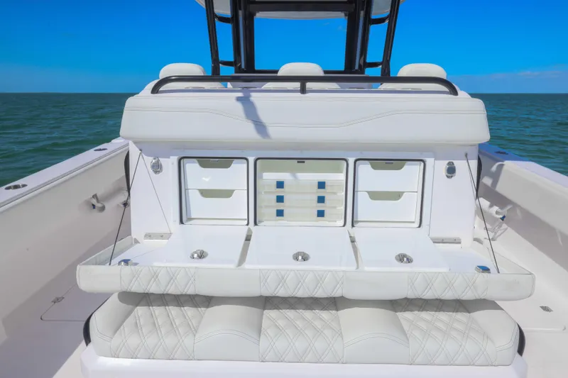 Slide: The Image of 2025 Invincible 35 Catamaran interior with seating and storage, ocean backdrop. - 23