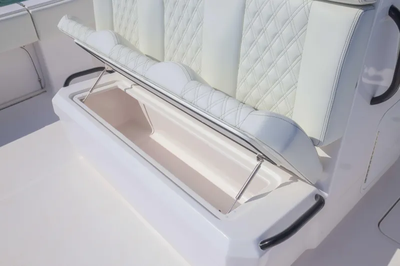 Slide: The Image of 2025 Invincible 35 Catamaran seat with storage compartment open, showcasing luxury design. - 24