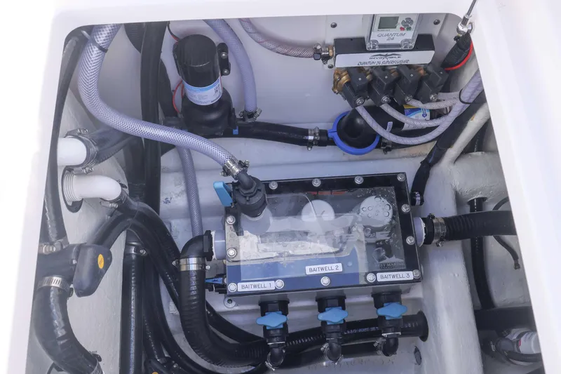 Slide: The Image of Engine compartment of 2025 Invincible 35 Catamaran with visible hoses and components. - 26