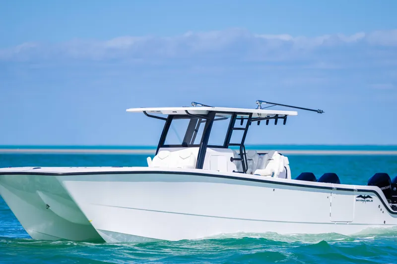 Slide: The Image of 2025 Invincible 35 Catamaran cruising on clear blue waters. - 3