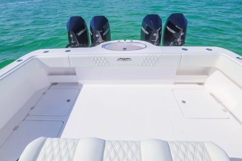 Slide: The Image of 2025 Invincible 35 Catamaran with quad Mercury engines on turquoise water. - 32