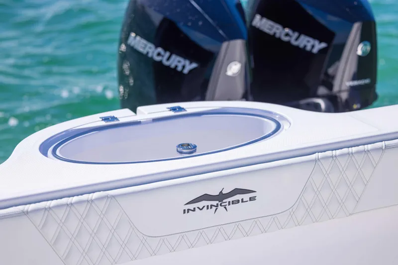 Slide: The Image of 2025 Invincible 35 Catamaran with Mercury engines on turquoise water. - 34