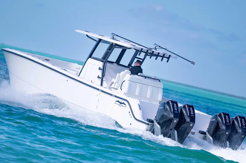 Slide: The Image of 2025 Invincible 35 Catamaran cruising on turquoise waters, featuring powerful outboard engines. - 37