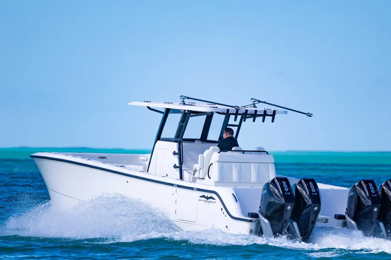 Slide: The Image of 2025 Invincible 35 Catamaran cruising on clear blue ocean waters. - 38