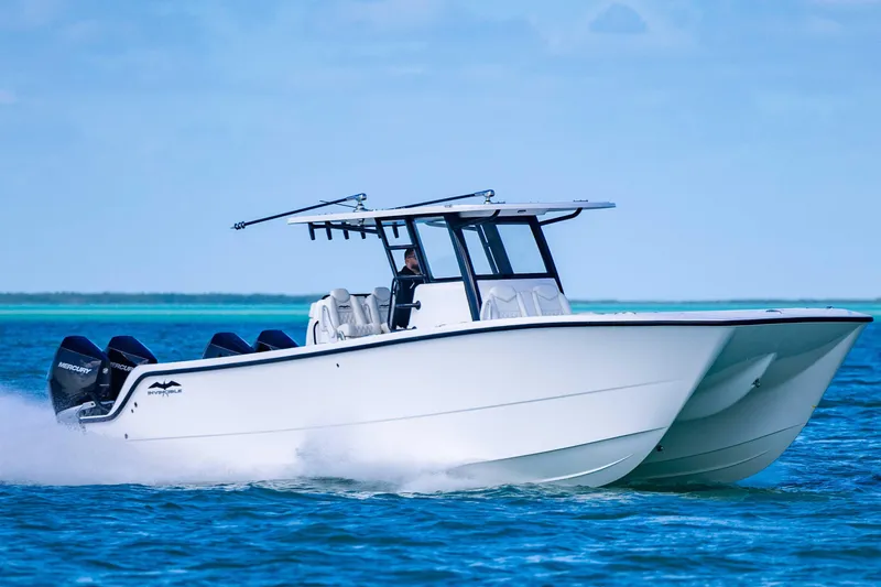 Slide: The Image of 2025 Invincible 35 Catamaran cruising on blue ocean waters. - 39