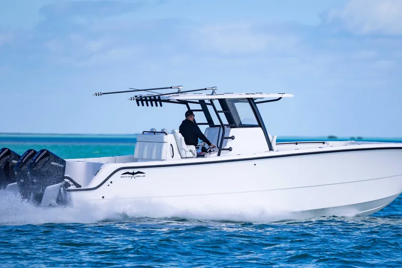 Slide: The Image of 2025 Invincible 35 Catamaran cruising on open water, showcasing sleek design and powerful engines. - 41