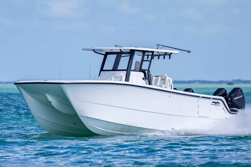 Slide: The Image of 2025 Invincible 35 Catamaran cruising on blue ocean waters. - 43