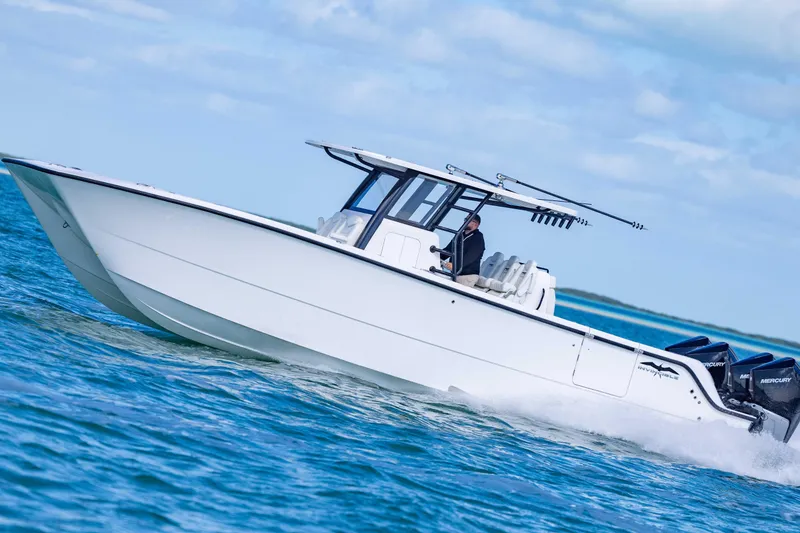 Slide: The Image of 2025 Invincible 35 Catamaran cruising on open water under a clear sky. - 45