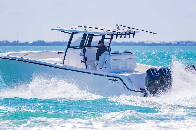 Slide: The Image of 2025 Invincible 35 Catamaran cruising on turquoise waters, showcasing sleek design and powerful engines. - 47